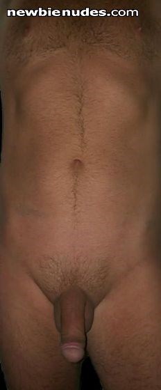 Full nude body. Closely trimmed pubic hair, Cock,balls, navel, nipples visible.